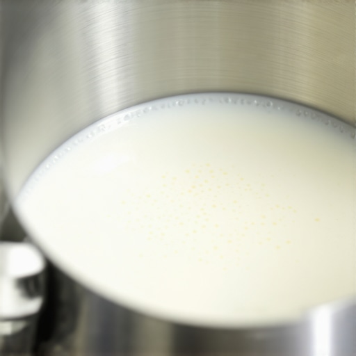 The Perfect Almond Milk Vortex Close-up of a milk pitcher showing the vortex effect needed to create microfoam with almond milk for latte art.